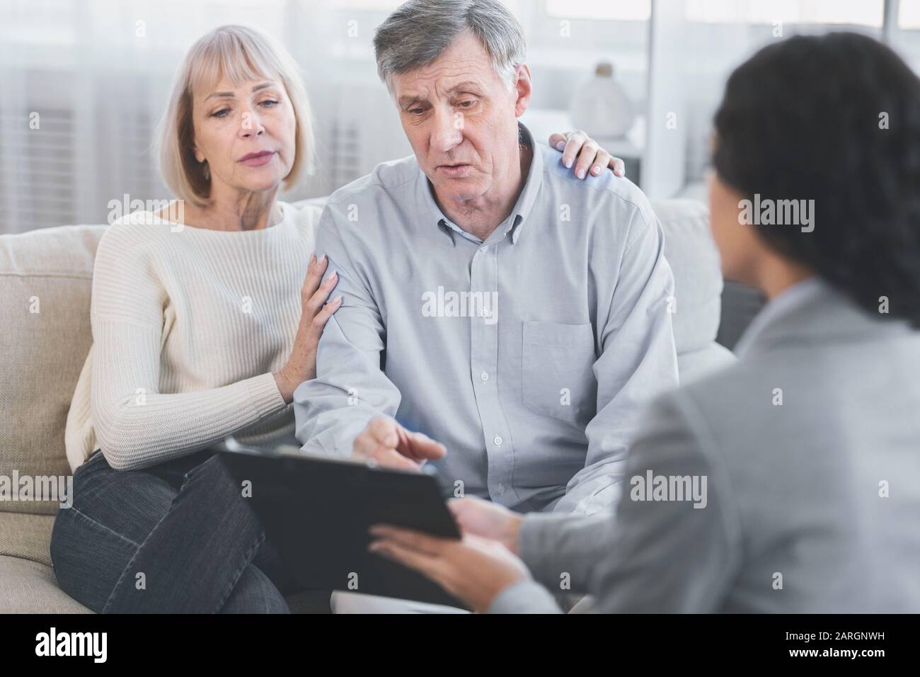 Senior couple talking to their financial advisor Stock Photo