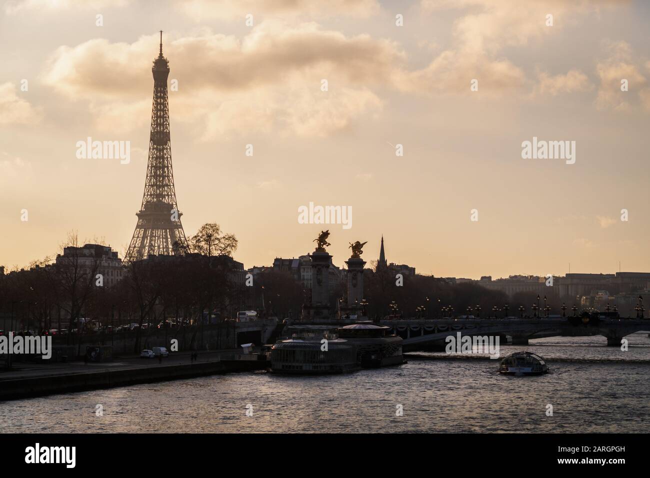 A beautiful view of Paris at sunset with the Eiffel Tower and the bridge Alexander III Stock Photo