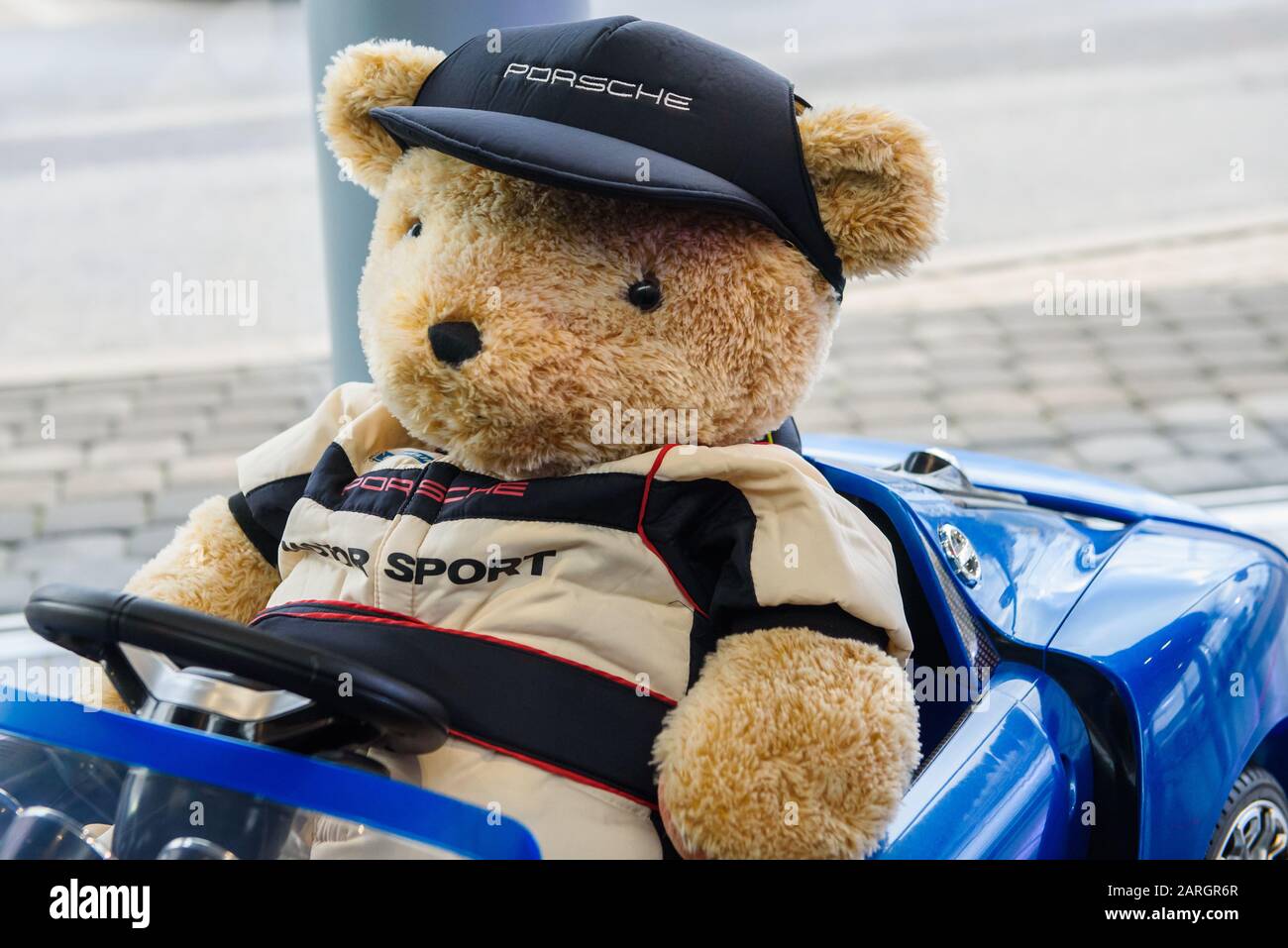 RIGA, LATVIA. 22nd January 2020. Teddy bear toy at Porsche toy car. Porsche is a German automobile manufacturer specializing in high-performance sports cars, SUVs and sedans. Stock Photo