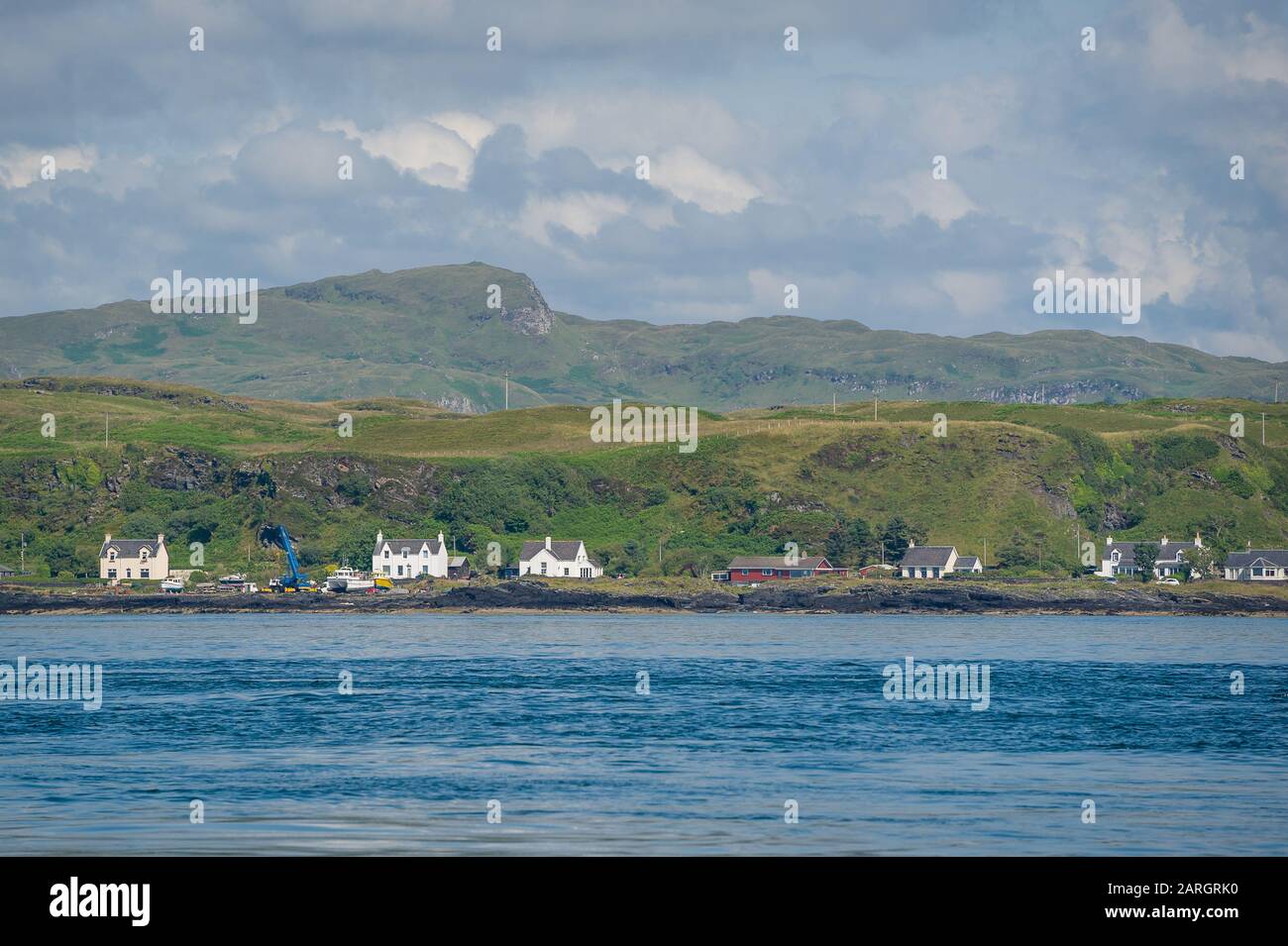Village at Scotland shore view from the water. Typical rural landscape of Hebrides islands. Stock Photo