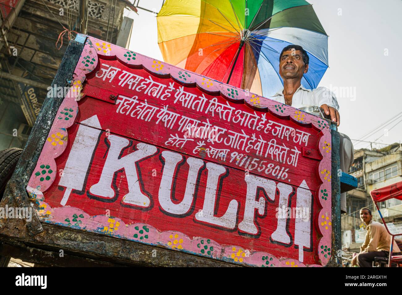 A street vendor is selling Kulfi, the local ice cream, on Khari Baoli Road in Old Delhi Stock Photo