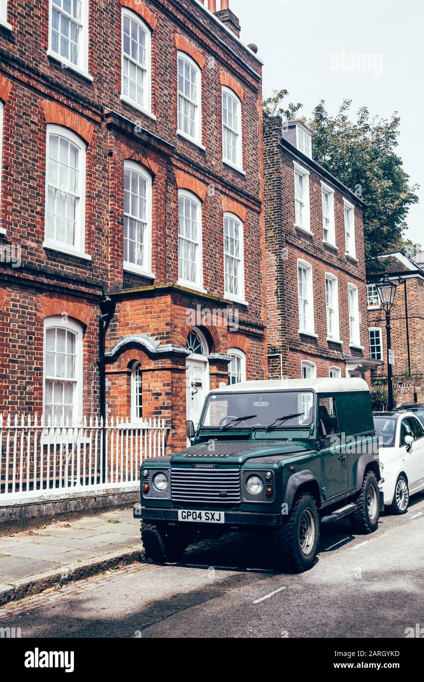 London/UK - 17/07/2019: dark green Land Rover Defender parked on a side of the road in London. British four-wheel drive off-road vehicle developed in Stock Photo