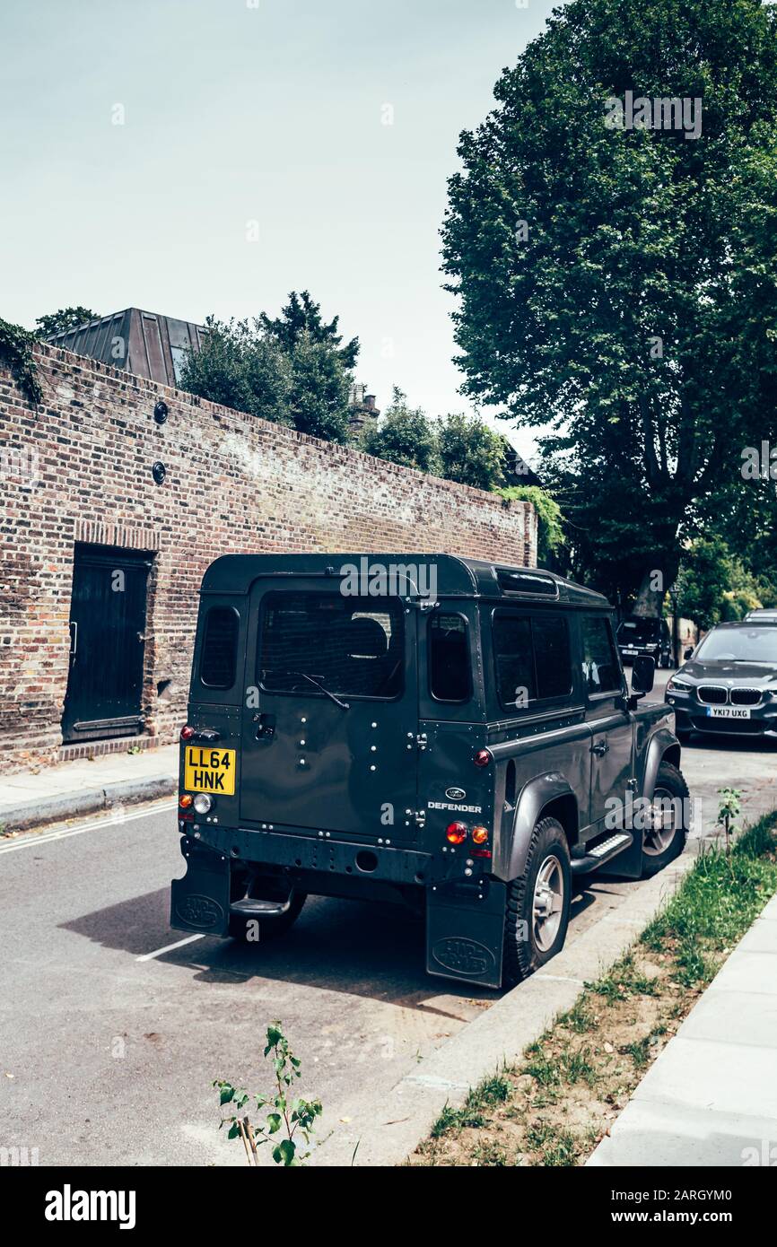 London/UK - 17/07/2019: Land Rover Defender parked on a side of the road in London. British four-wheel drive off-road vehicle developed in the 1980s f Stock Photo