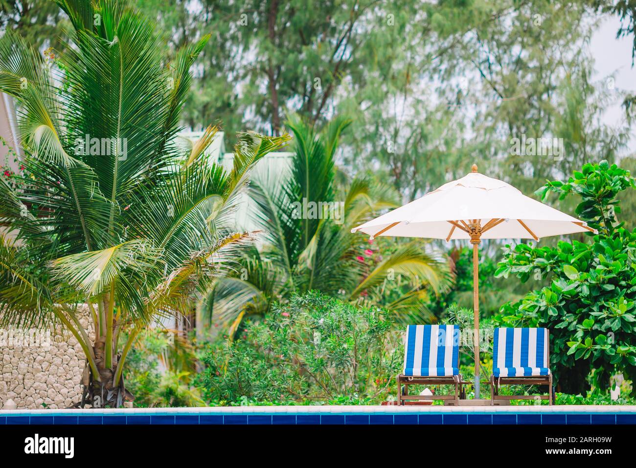Beach lounge chairs on beautiful tropical luxury resort Stock Photo Alamy