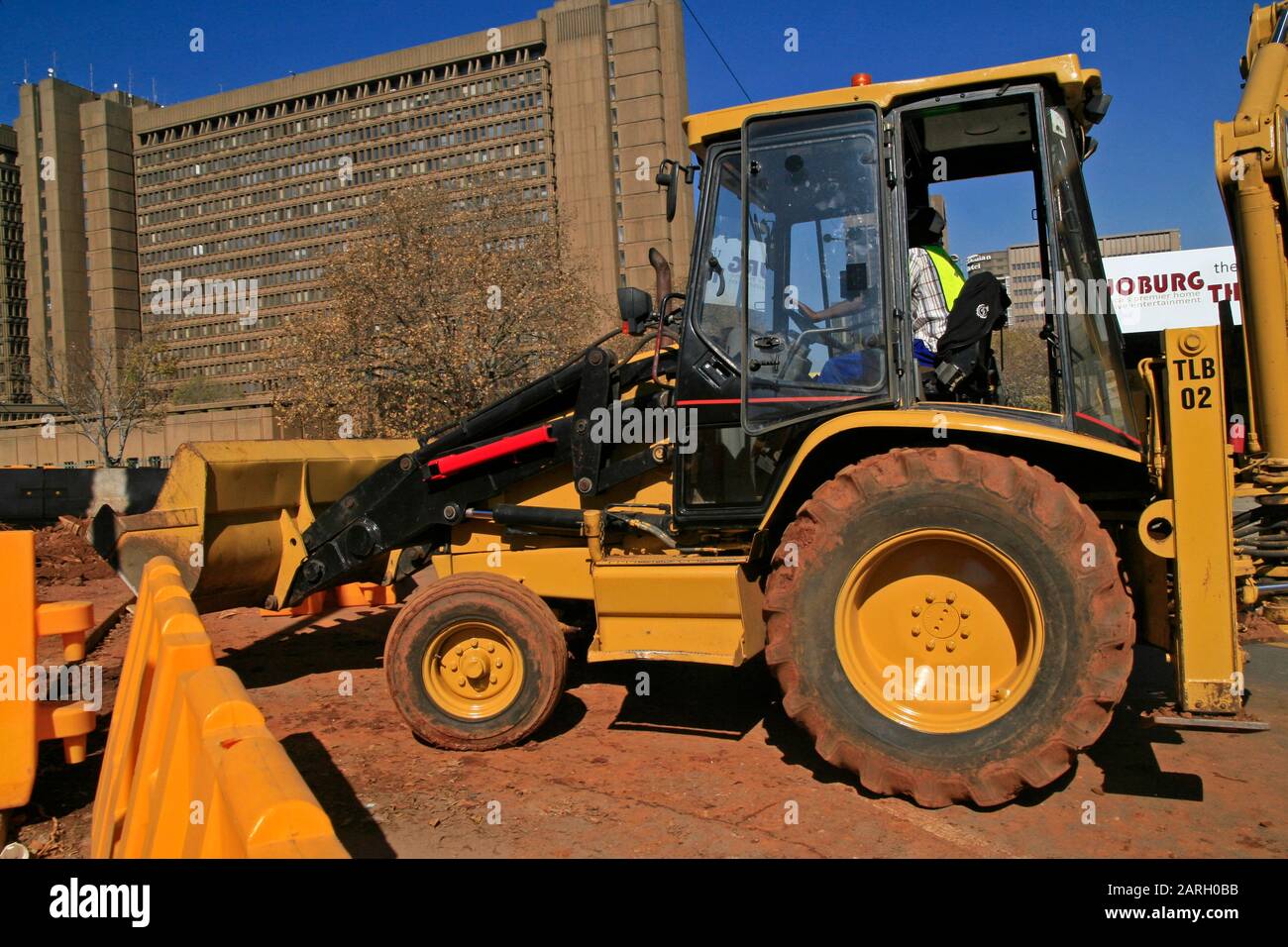 Caterpillar construction tractor with roadworker inside in front of