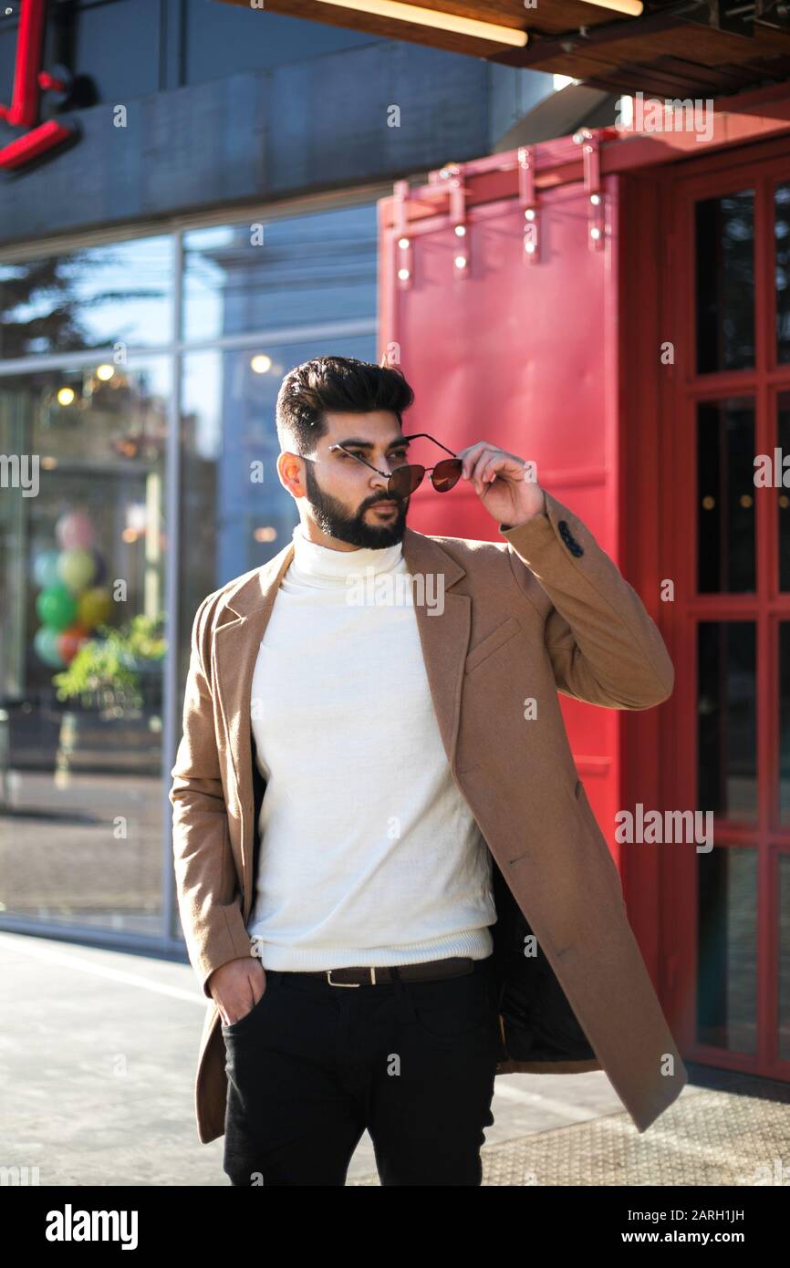 Portrait of fashionable well dressed bearded man at street. Young Indian man in brown coat posing outdoors looking away Stock Photo - Alamy Portrait of fashionable well dressed bearded man at street. Young Indian man in brown coat posing outdoors looking away Stock Photo - Alamy