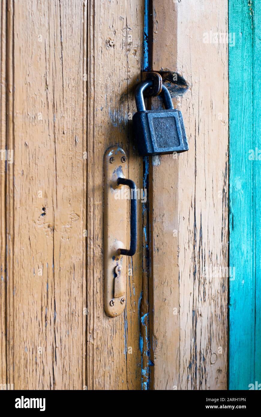 Old closed door with padlock and knob, vertical shot Stock Photo - Alamy