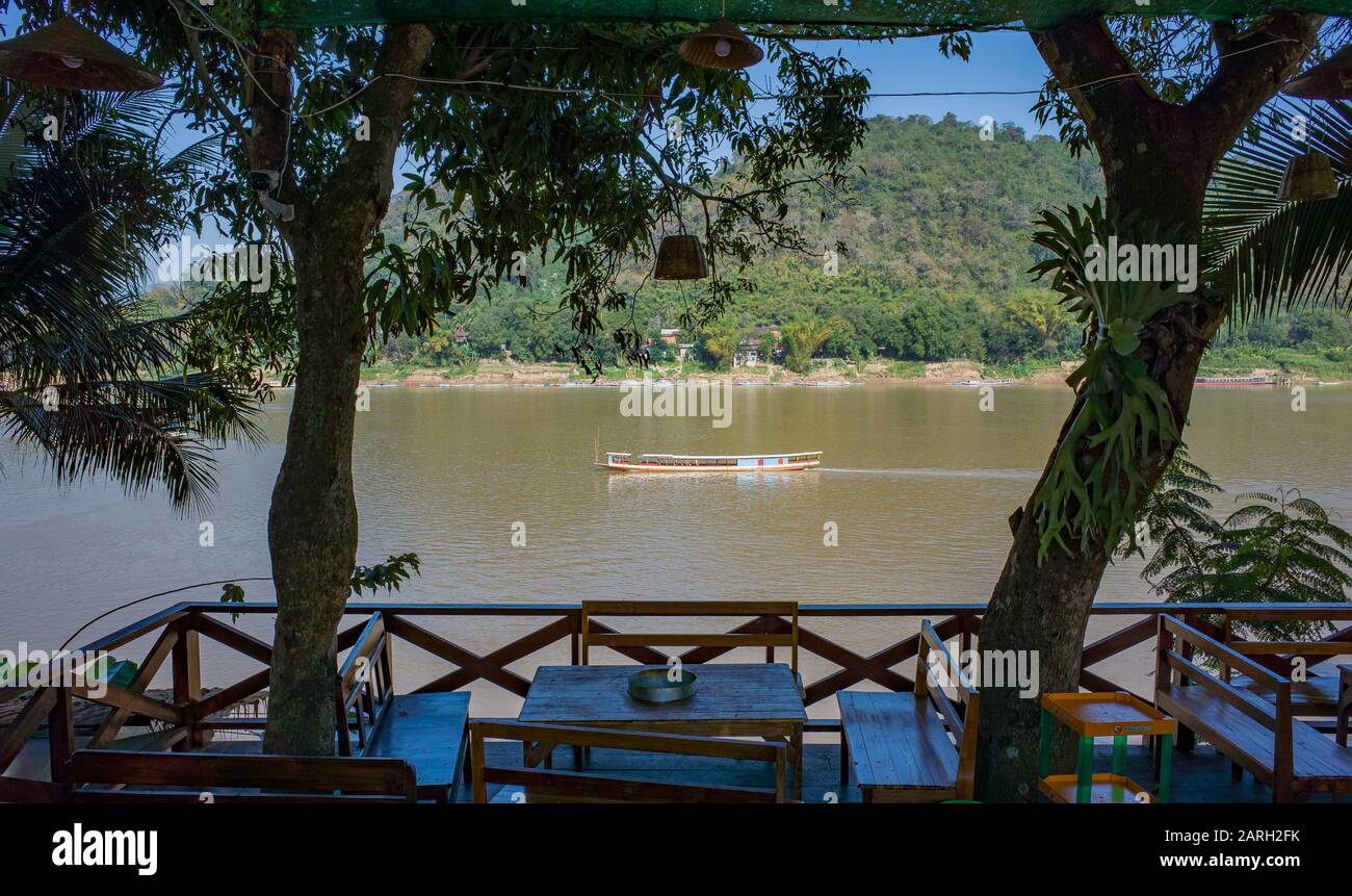 Restaurant dining table overlooking the Mekong river in Luang Prabang, Laos Stock Photo