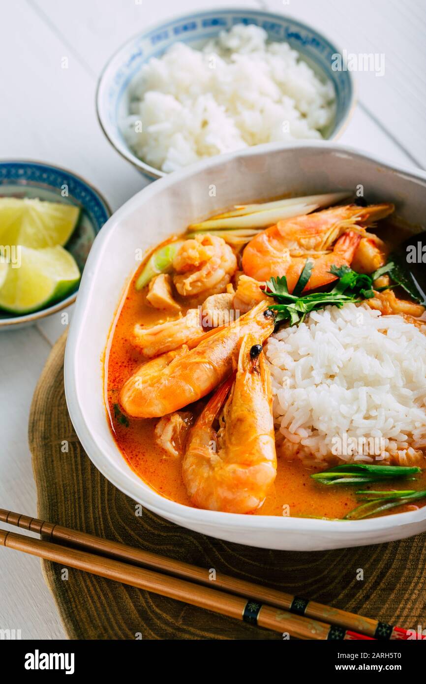 Tasty Tom Yam with shrimp and rice, spicy Thai soup, close-up Stock Photo