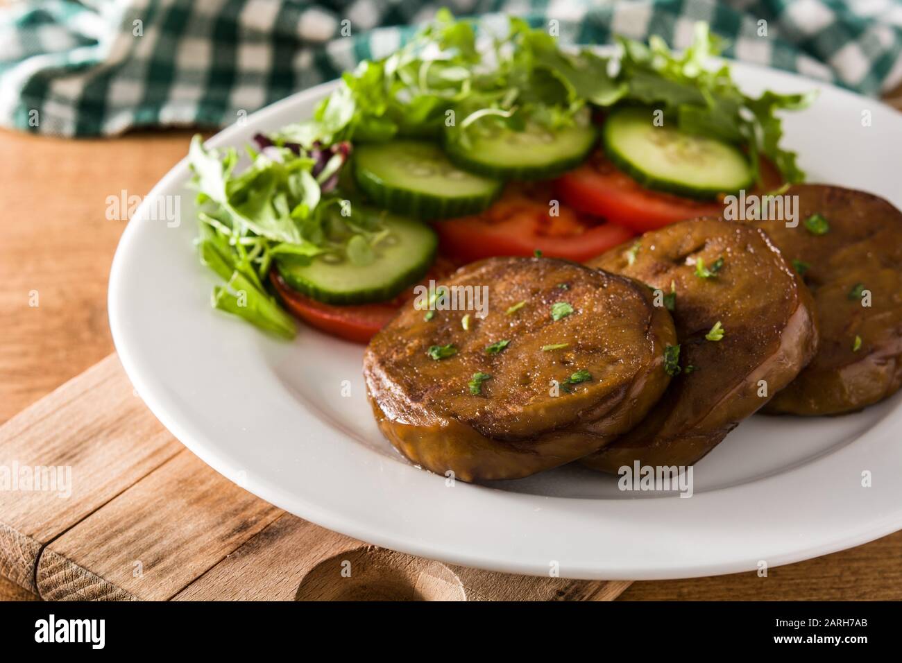 Seitan with vegetables on wooden table. Fake meat Stock Photo Alamy