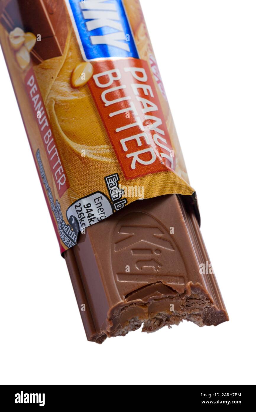 Nestle KitKat chunky peanut butter chocolate bar opened and bitten into, eating set on white