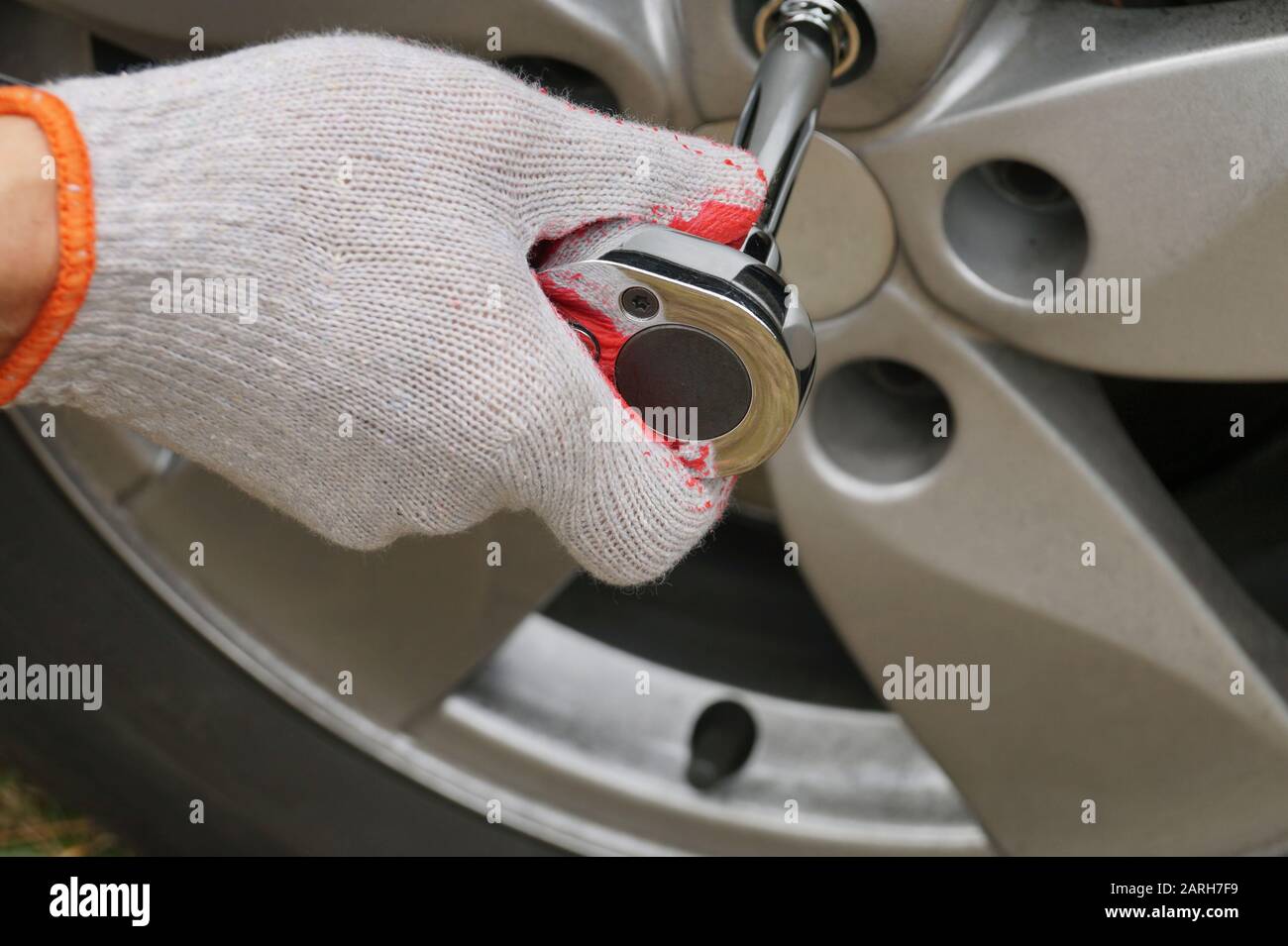 Screwing the car wheel with a torque wrench. Car repair Stock