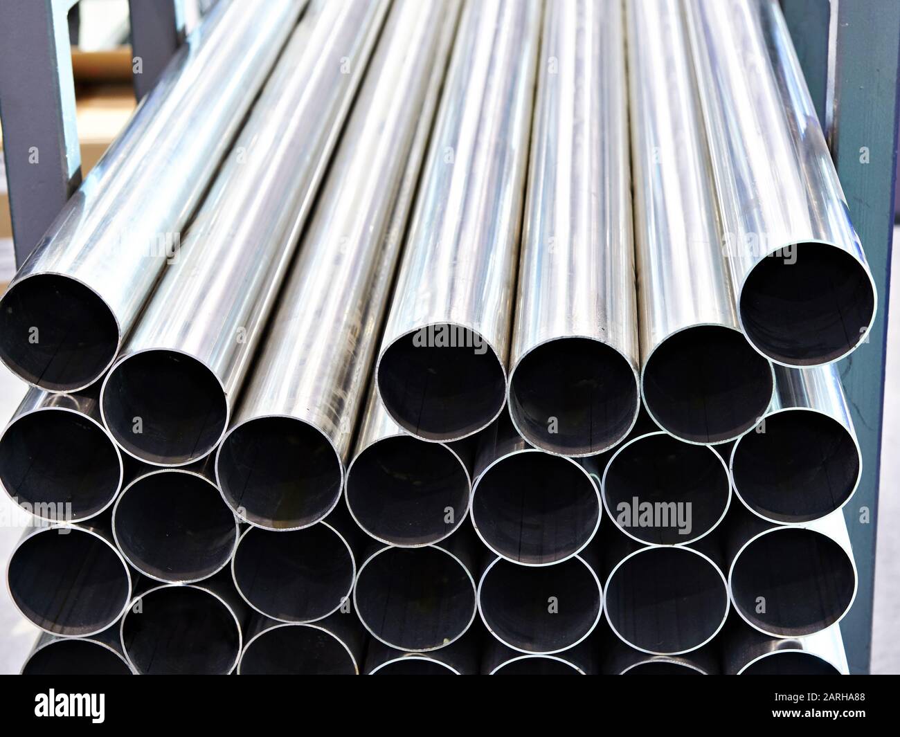 Steel pipes in stack closeup Stock Photo - Alamy