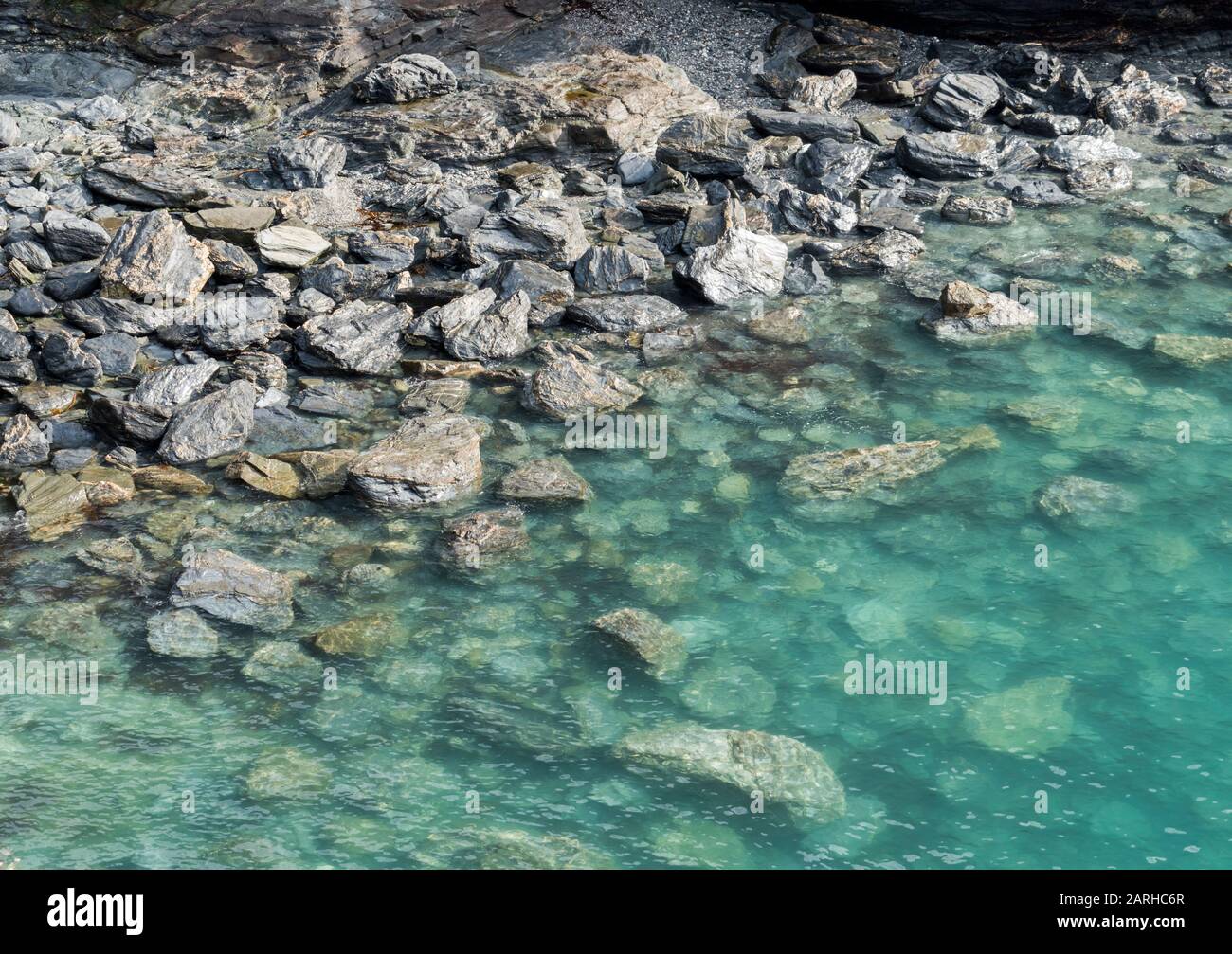 Crystal Clear Turquoise Waters Over Rocks On The Beach Cornwall