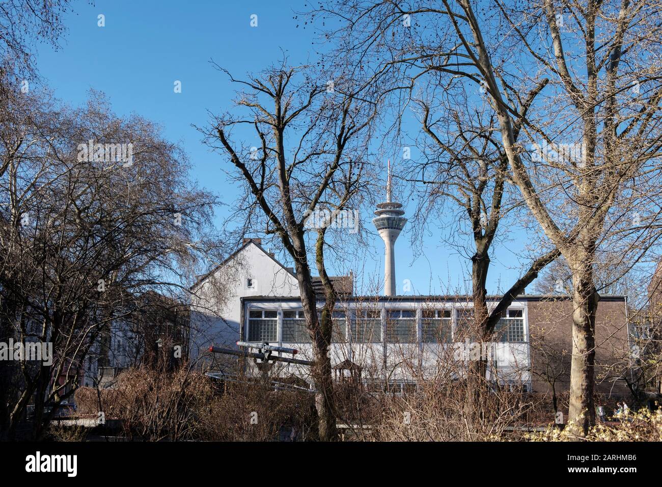 playground and exterior of old school sports gym building with TV tower