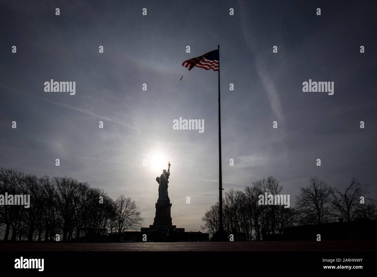 New York , USA. Statue of Liberty in silhouette on Liberty Island. Stock Photo