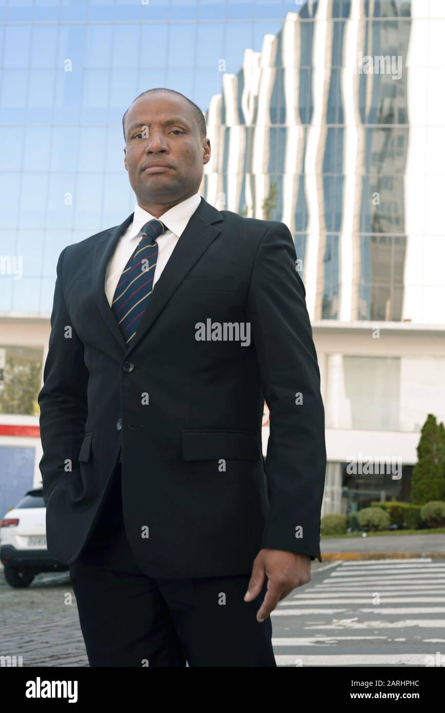 Black businessman in a suit looking successfull in an urban background Stock Photo