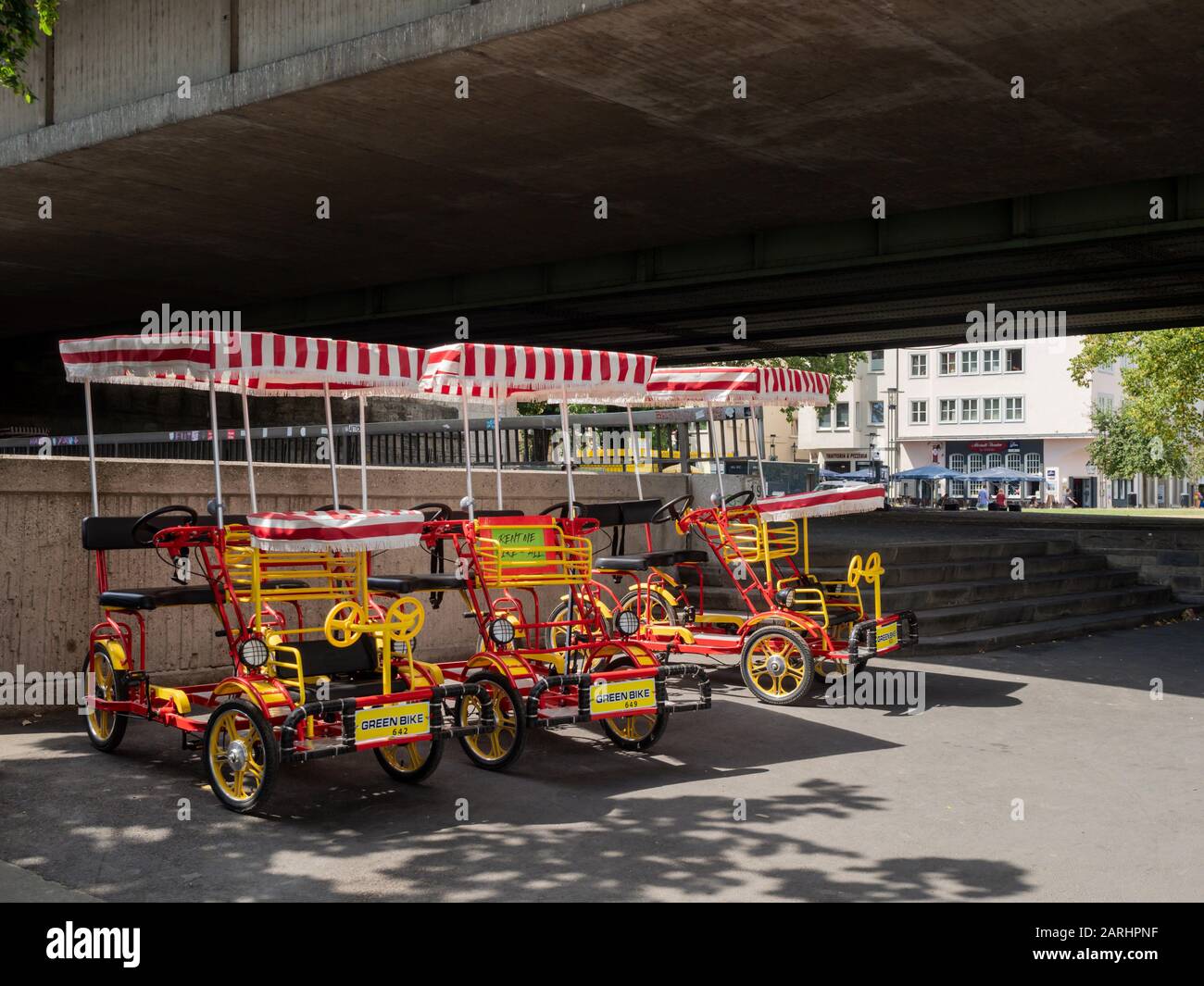 COLOGNE, GERMANY - JULY 05, 2019:  Quadracycle, four-wheeled human-powered bikes, for hire to tourists as a green alternative way to see the city Stock Photo