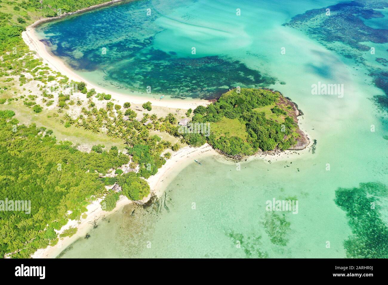 A lagoon with a coral reef and a white sandy beach, a view from above. The coast of a tropical island. Summer and travel vacation concept. Caramoan Islands, Philippines. Stock Photo