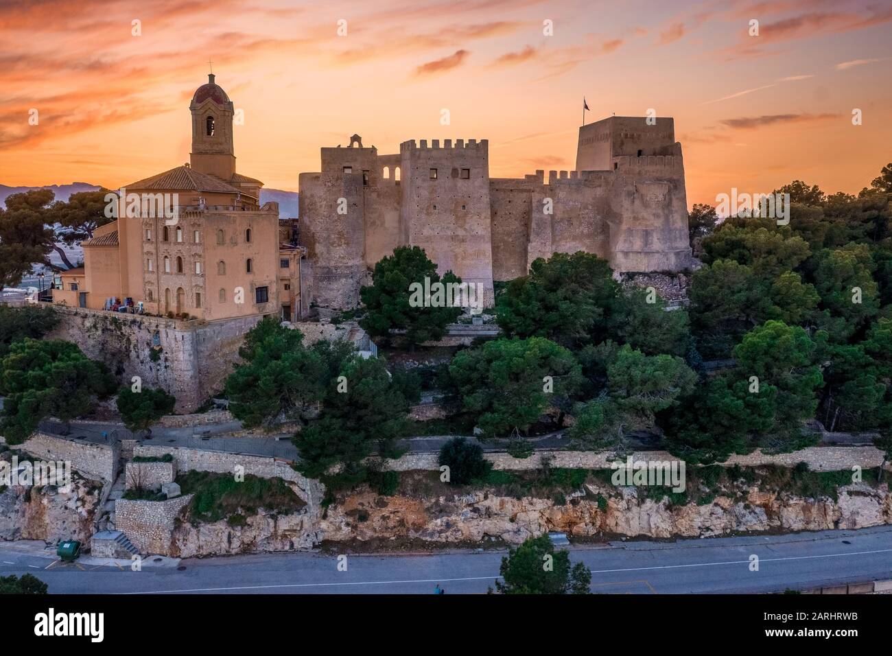 Aerial sunset panorama view of Cullera castle and popular seaside resort vacation town near Valencia Spain Stock Photo