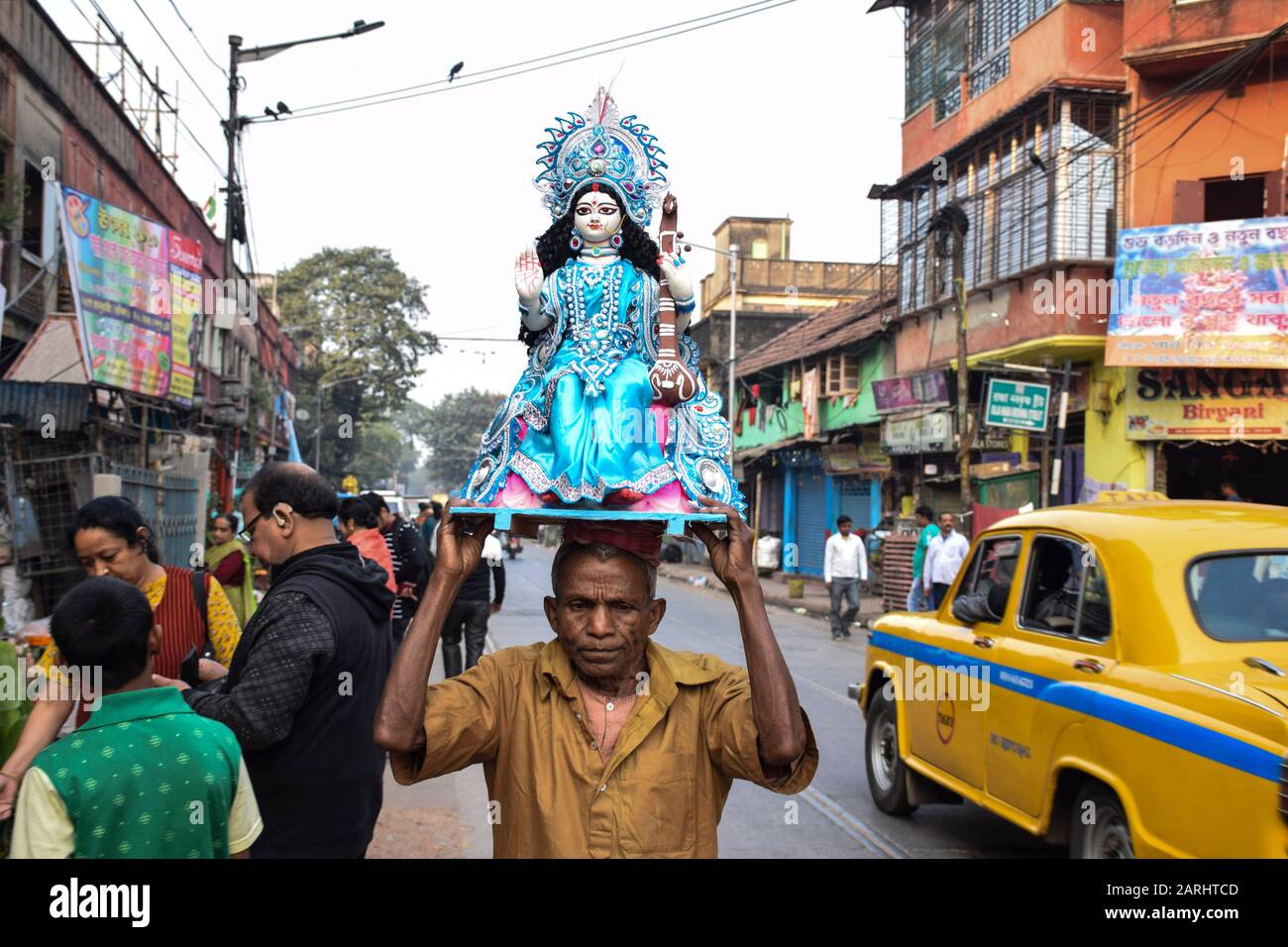 A man carrying an idol during the preparation.Basant panchami, is the