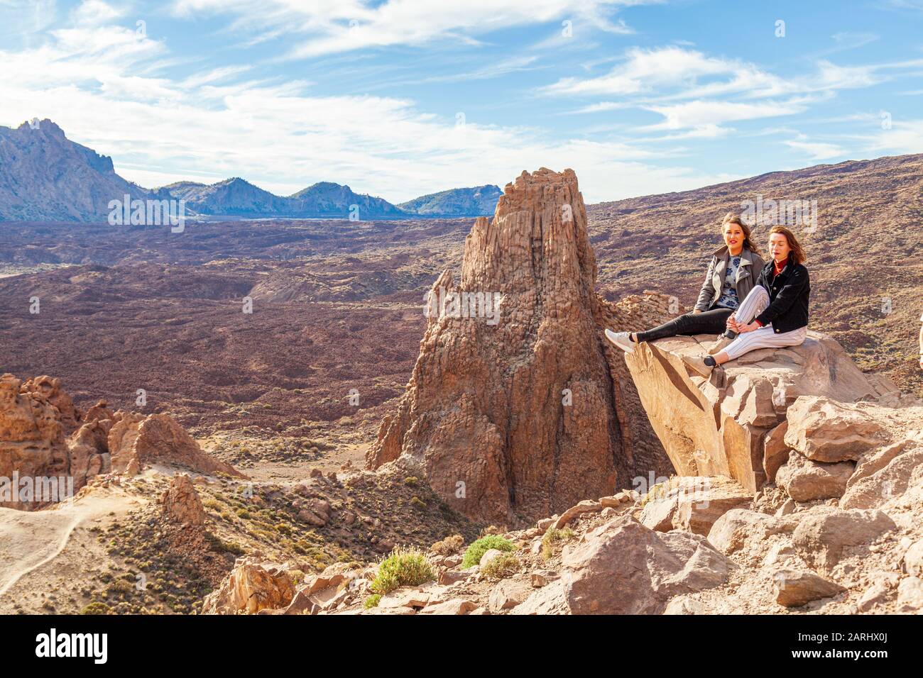 Women sitting on rock hi-res stock photography and images - Alamy