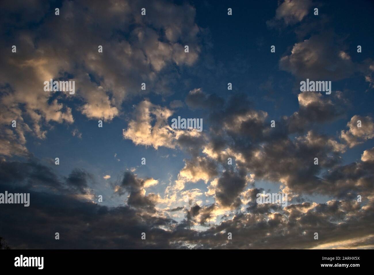 Beautiful evening clouds showing clear blue sky overhead Stock Photo ...