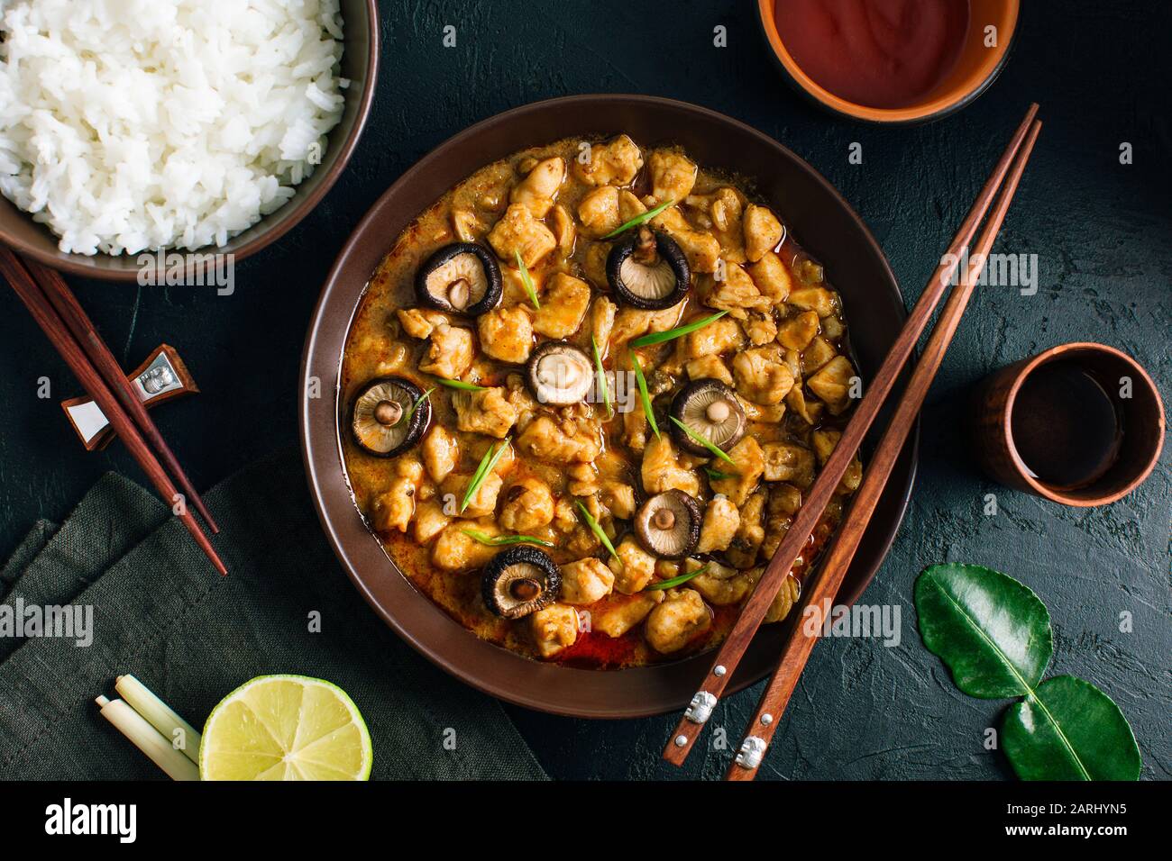 Panang Gai, Delicious spicy Thai food of chicken with shiitaki mushrooms on a black background Stock Photo