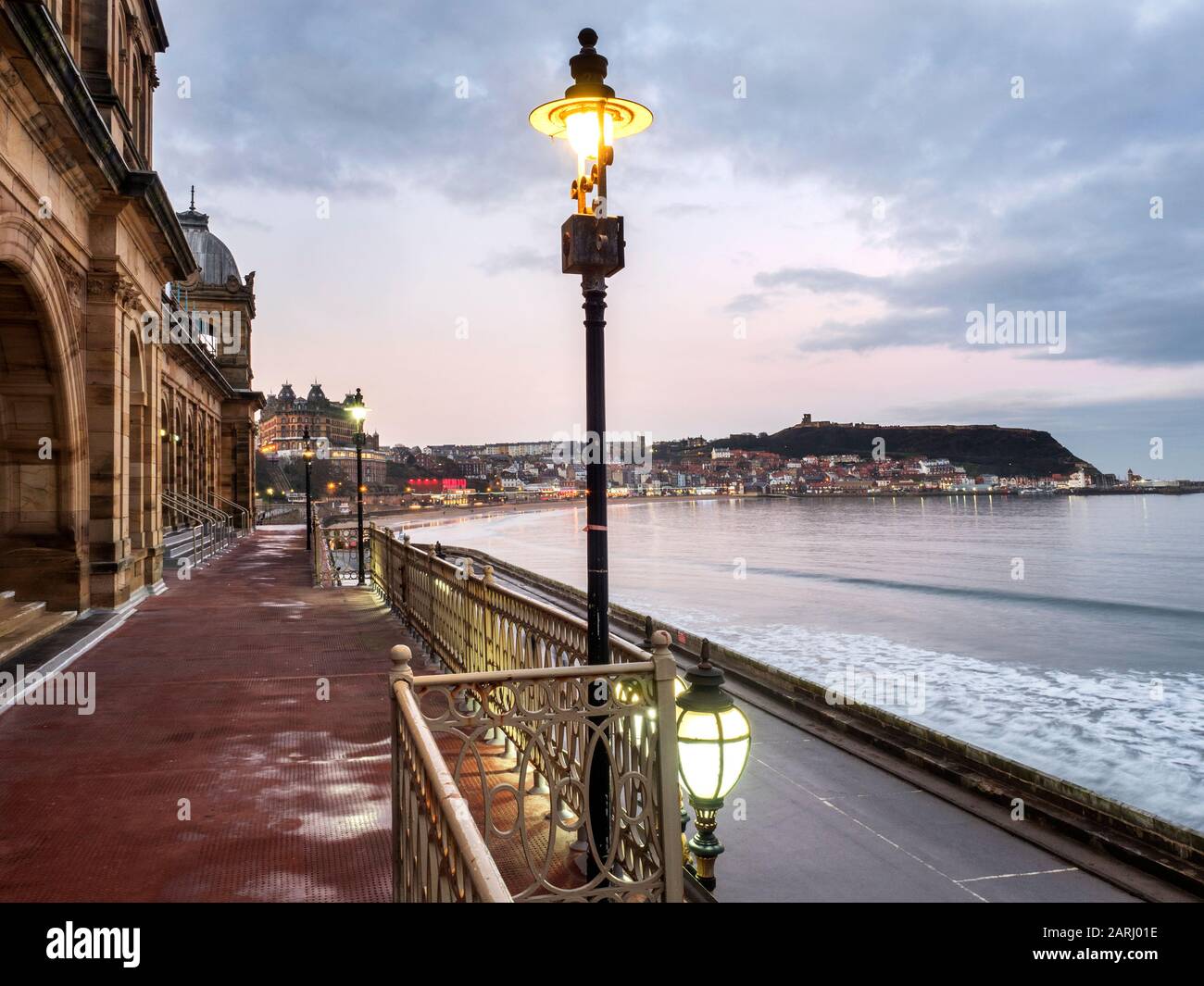 View from Scarborough Spa at dusk across South Bay towards Castle Hill Scarborough North Yorkshire England Stock Photo
