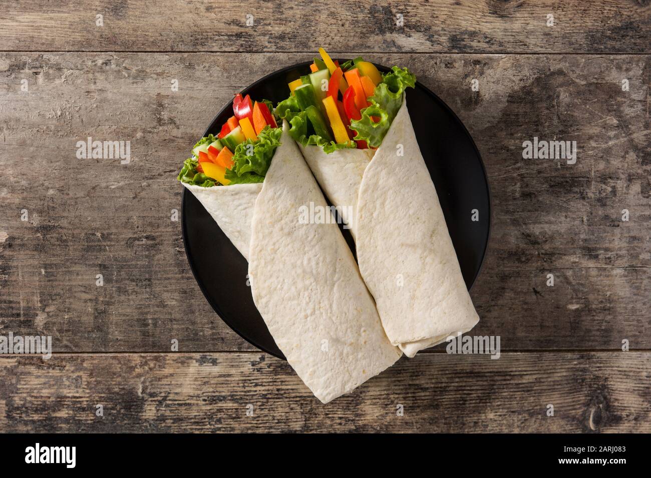 Vegetable tortilla wraps on wooden table. Top view Stock Photo Alamy