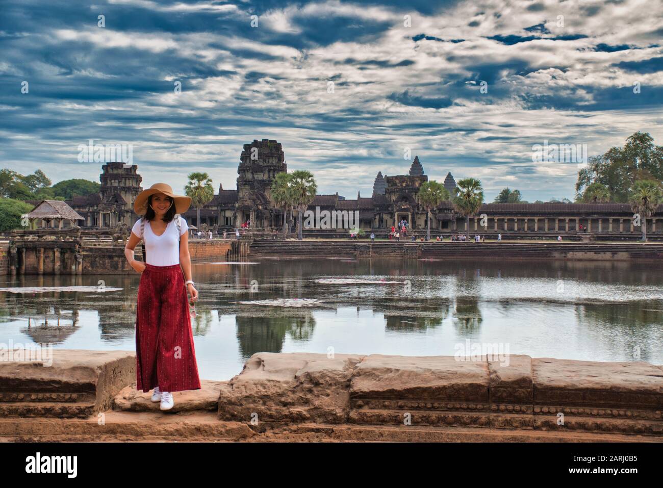 Beautiful, pretty, young Thai girl is exploring the ancient ruins of Angkor Wat (City/Capital of Temples) Hindu temple complex in Siem Reap, Cambodia Stock Photo