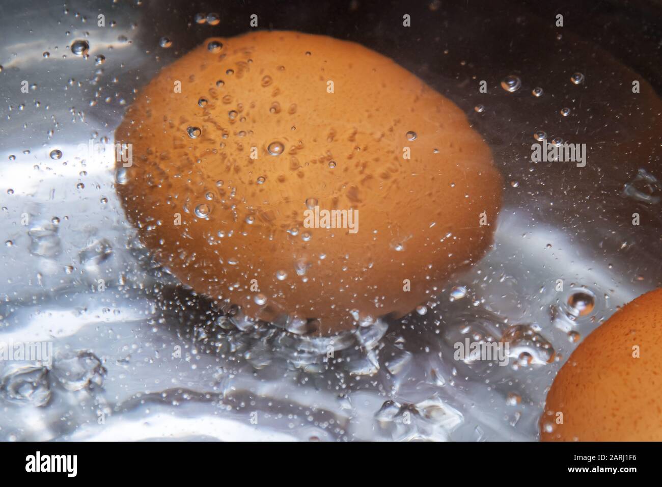Eggs are boiled in boiling water close up, copy space Stock Photo Alamy