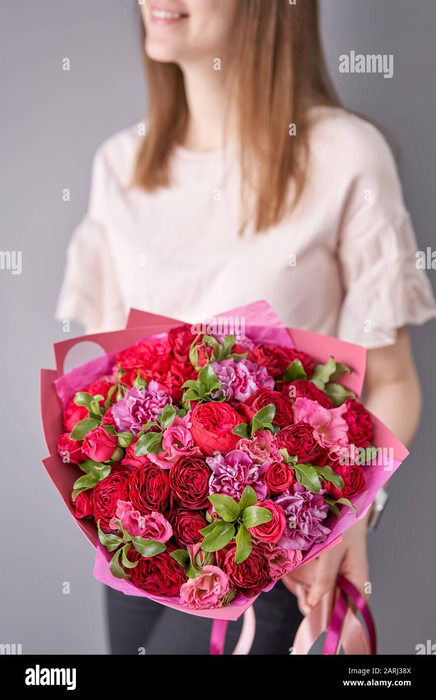 European floral shop. Beautiful bouquet of mixed flowers in womans
