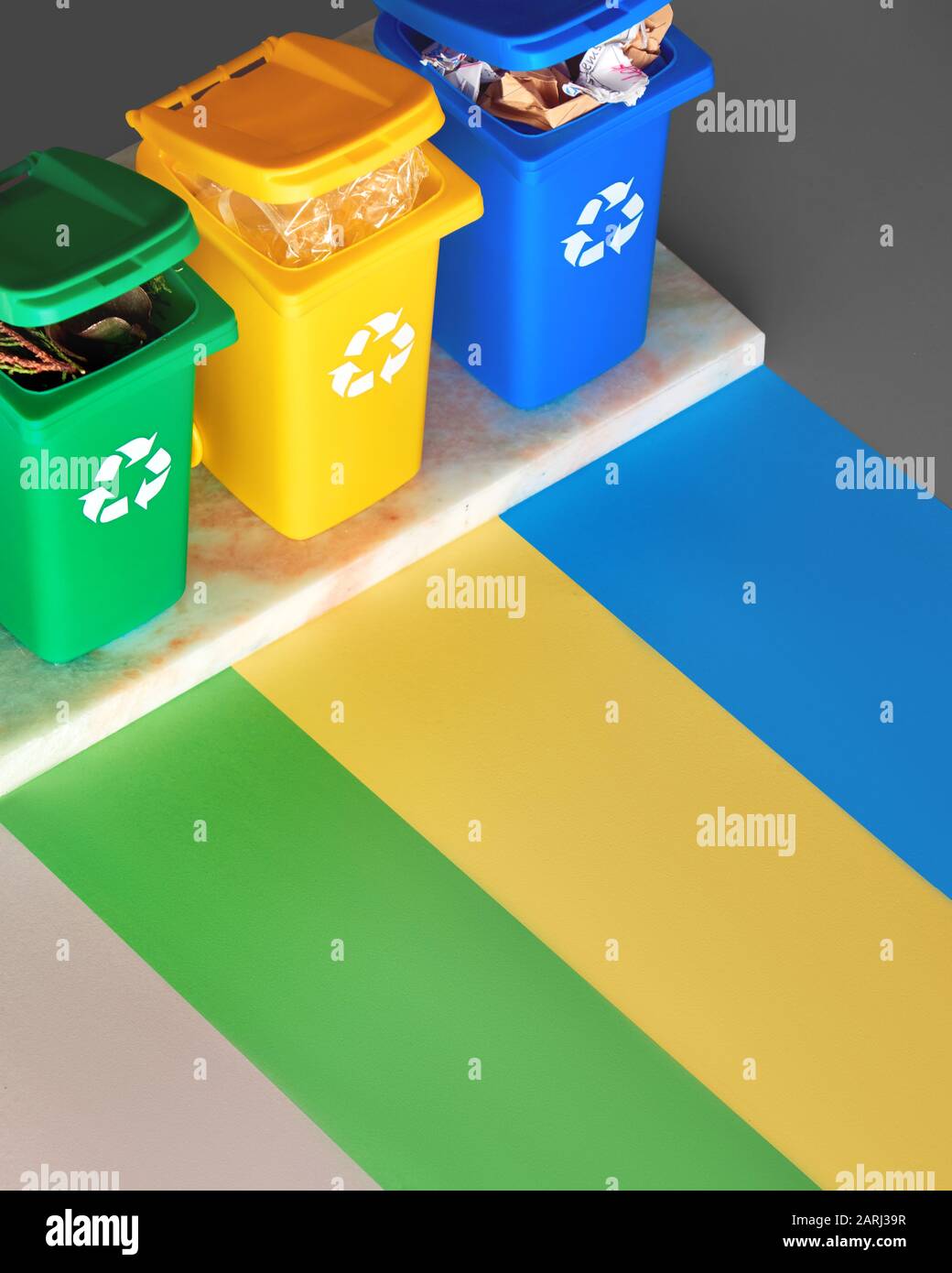 Three color coded recycle bins, isometric projection on paper color  stripes, three tone layered background with copy-space. Recycling concept  design f Stock Photo - Alamy