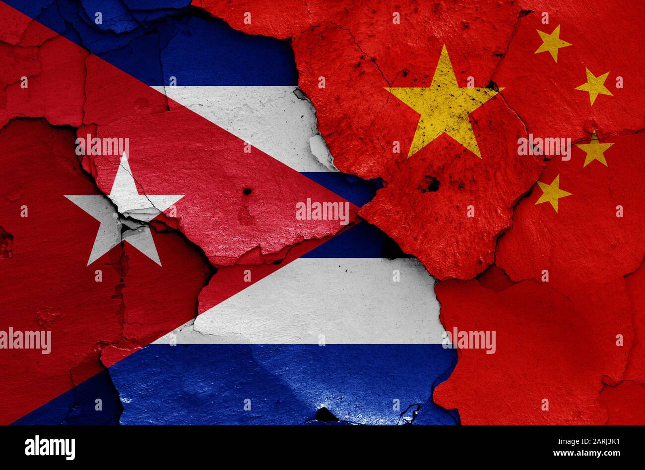 flags of Cuba and China painted on cracked wall Stock Photo