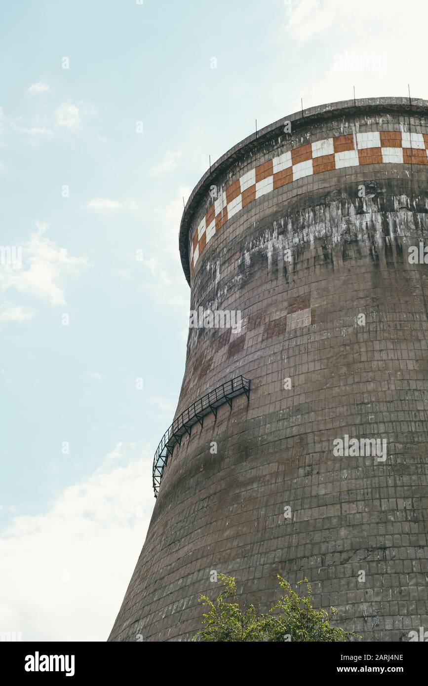 incredibly huge, old, industrial chimney made of concrete blocks. Concept of preserving the environment and taking care of nature Stock Photo