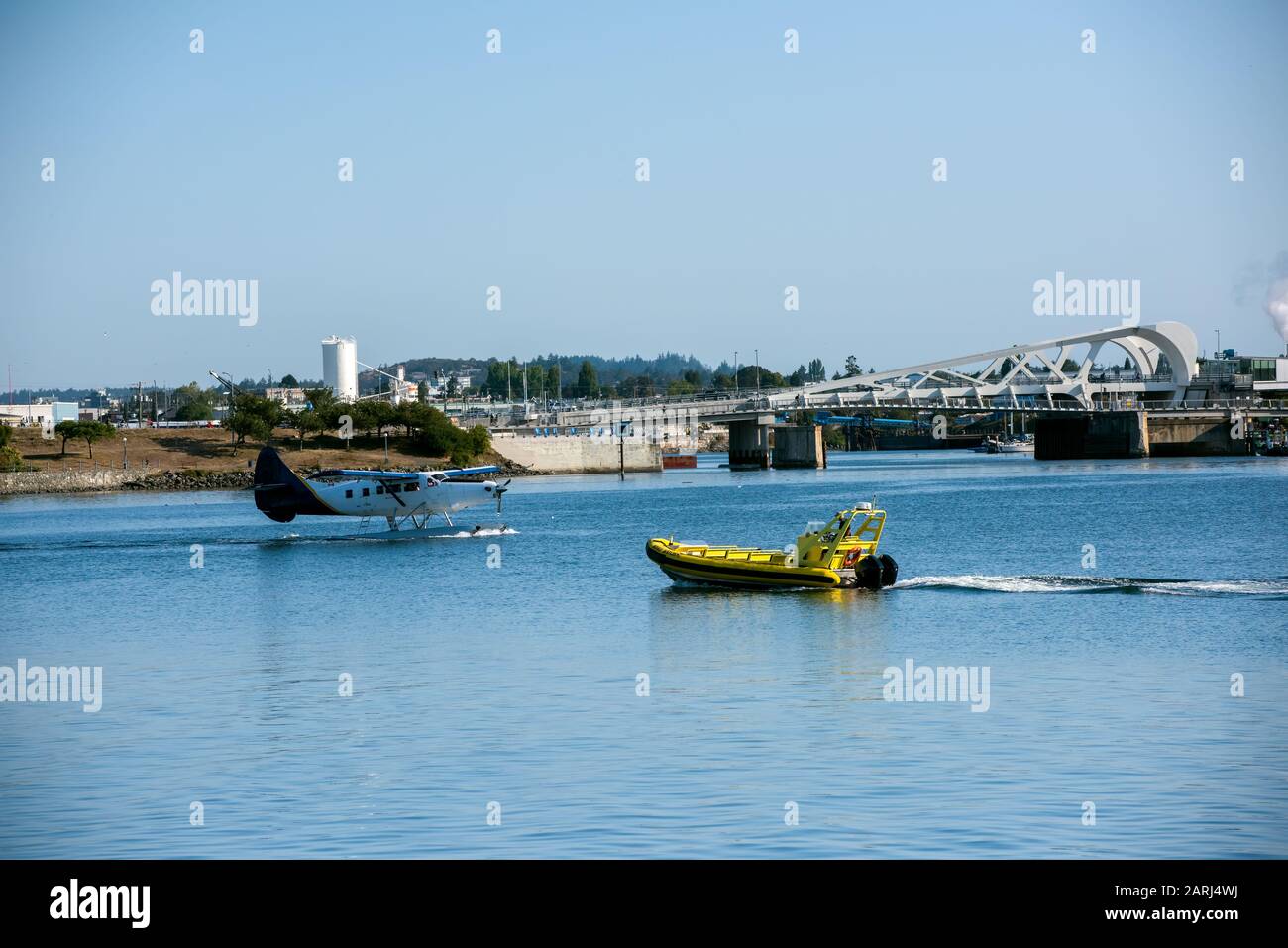 A float plane and whale-watching boat pass in the Victoria (Canada) Harbour. Stock Photo