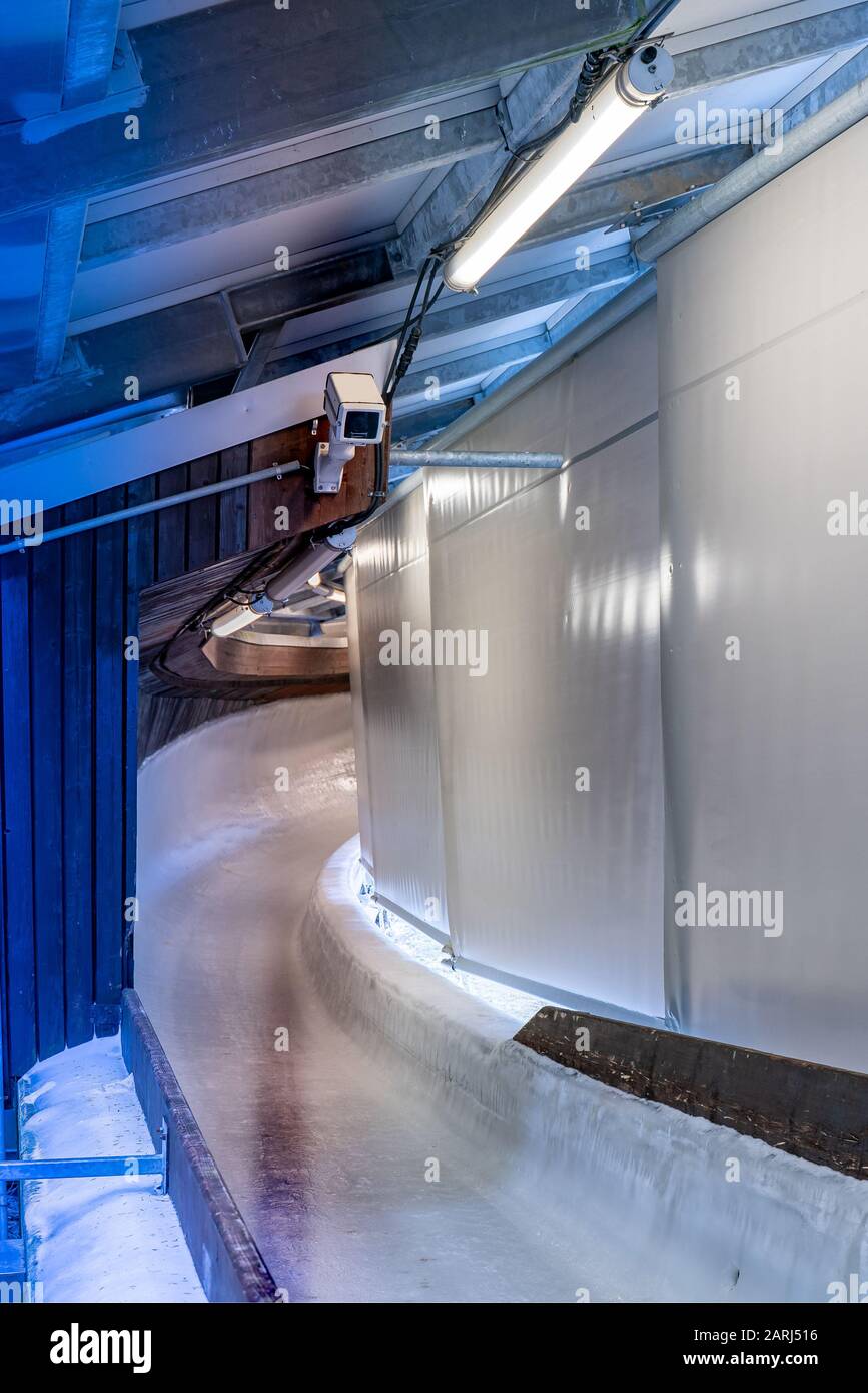 Bobsleigh ice channel in Winterberg. The digital clock measures the speed. Curvy trail in the ice. Stock Photo
