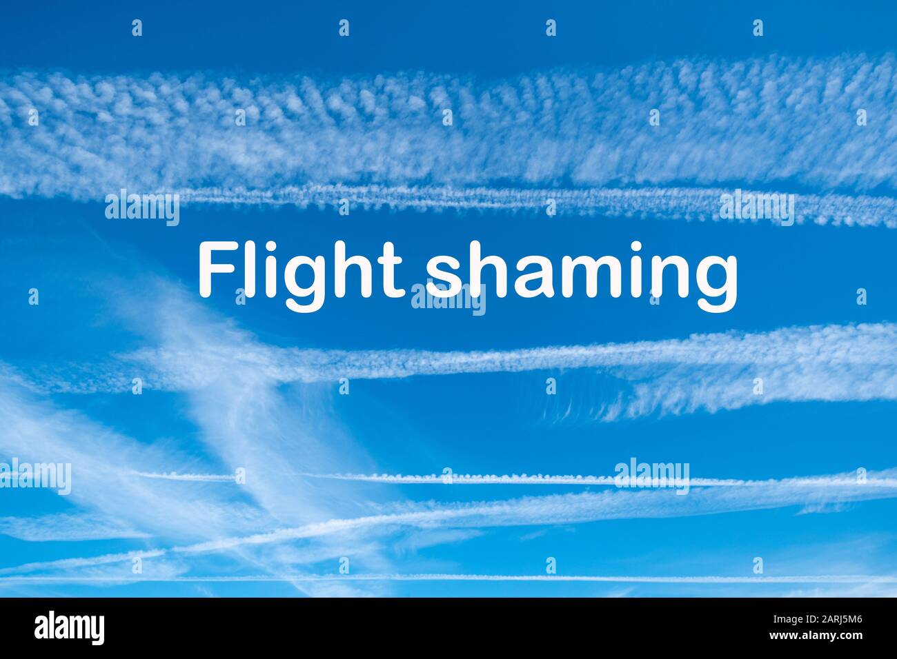 Climate change concept image with blue sky and vapour trails from aircraft with the words Flight Shaming Stock Photo
