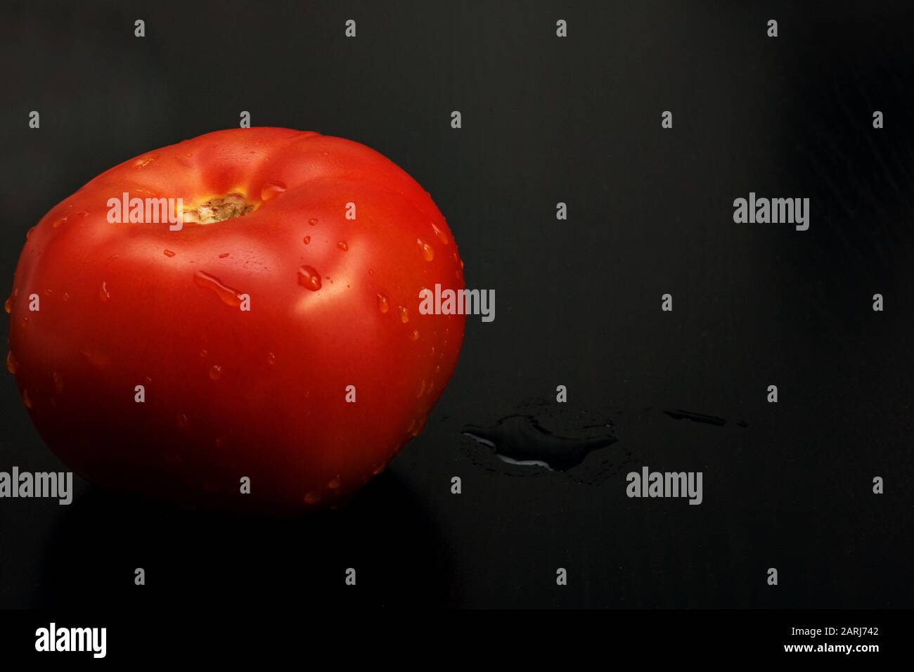 Red tomato with water drops on a dark background, copy space Stock ...