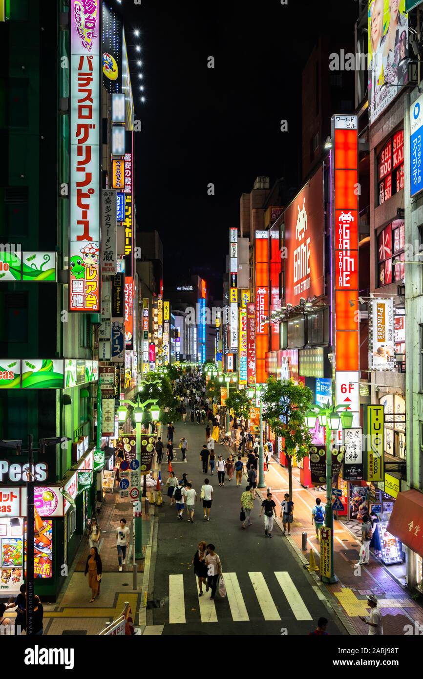 Shinjuku is a bustling district of Tokyo famous for neon signs and lights of shops, malls and restaurants. Tokyo, Japan, August 2019 Stock Photo