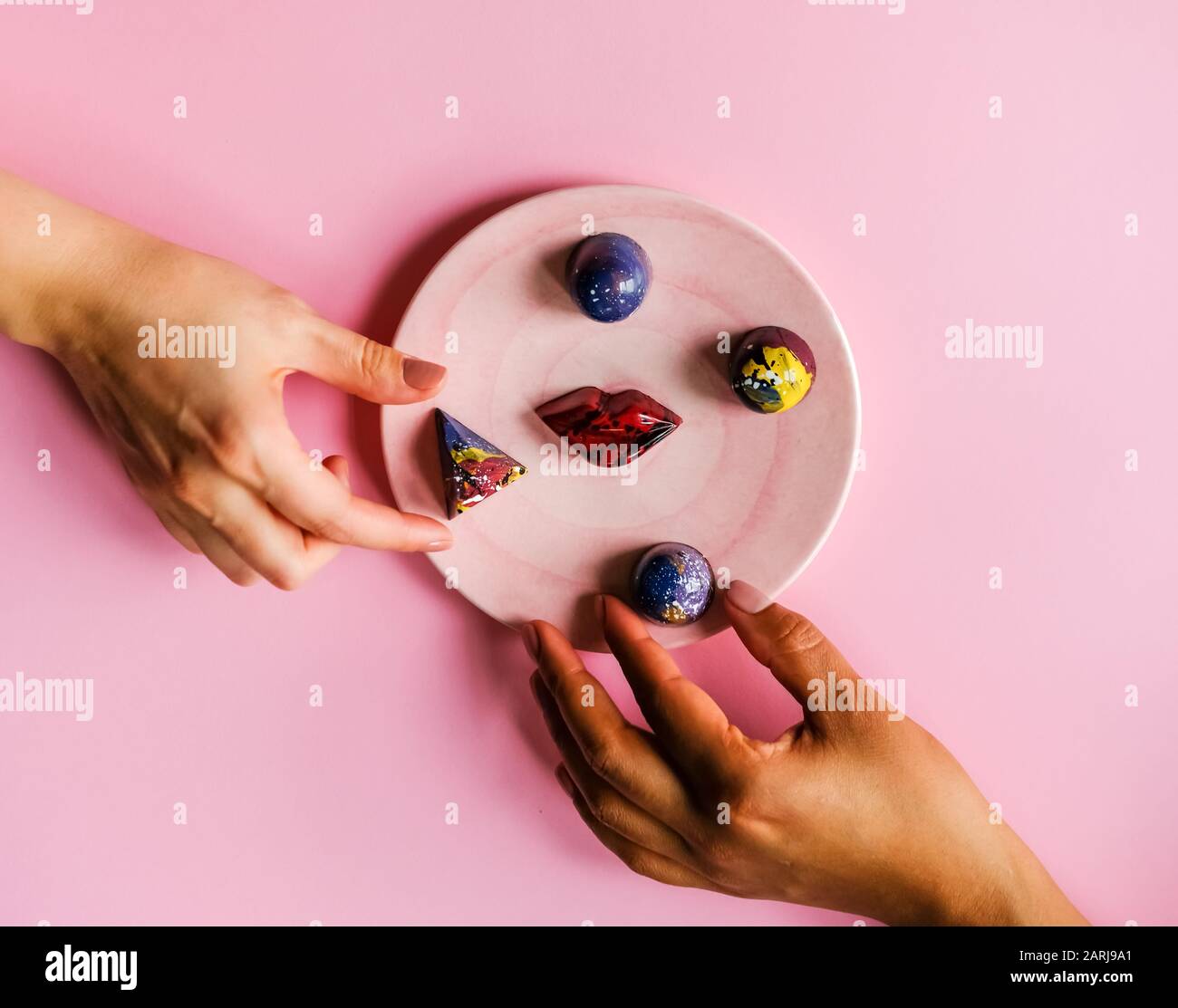 Hands and chocolates Stock Photo Alamy