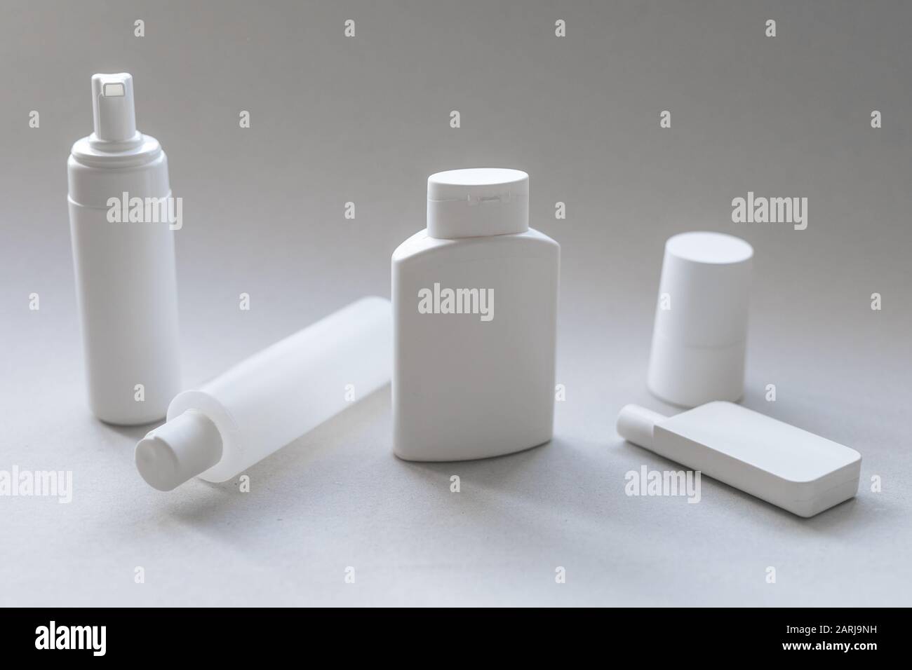 A compilation of white plastic cosmetic containers for body and face care A compilation of white plastic cosmetic containers for body and face care Stock Photo