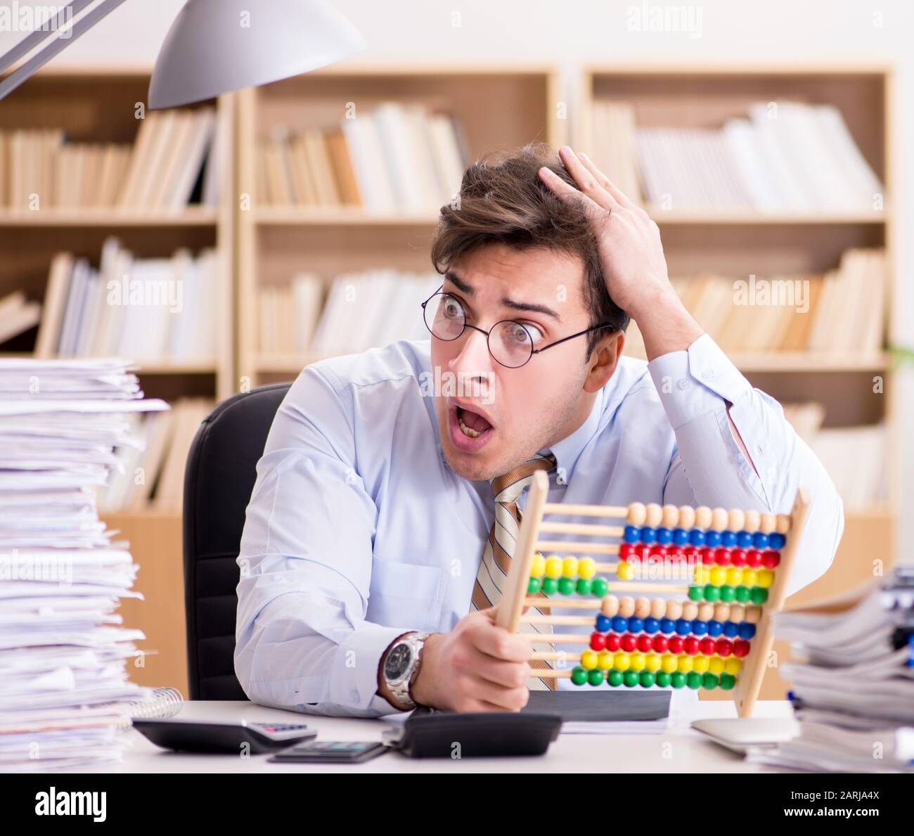 The funny accountant bookkeeper working in the office Stock Photo - Alamy