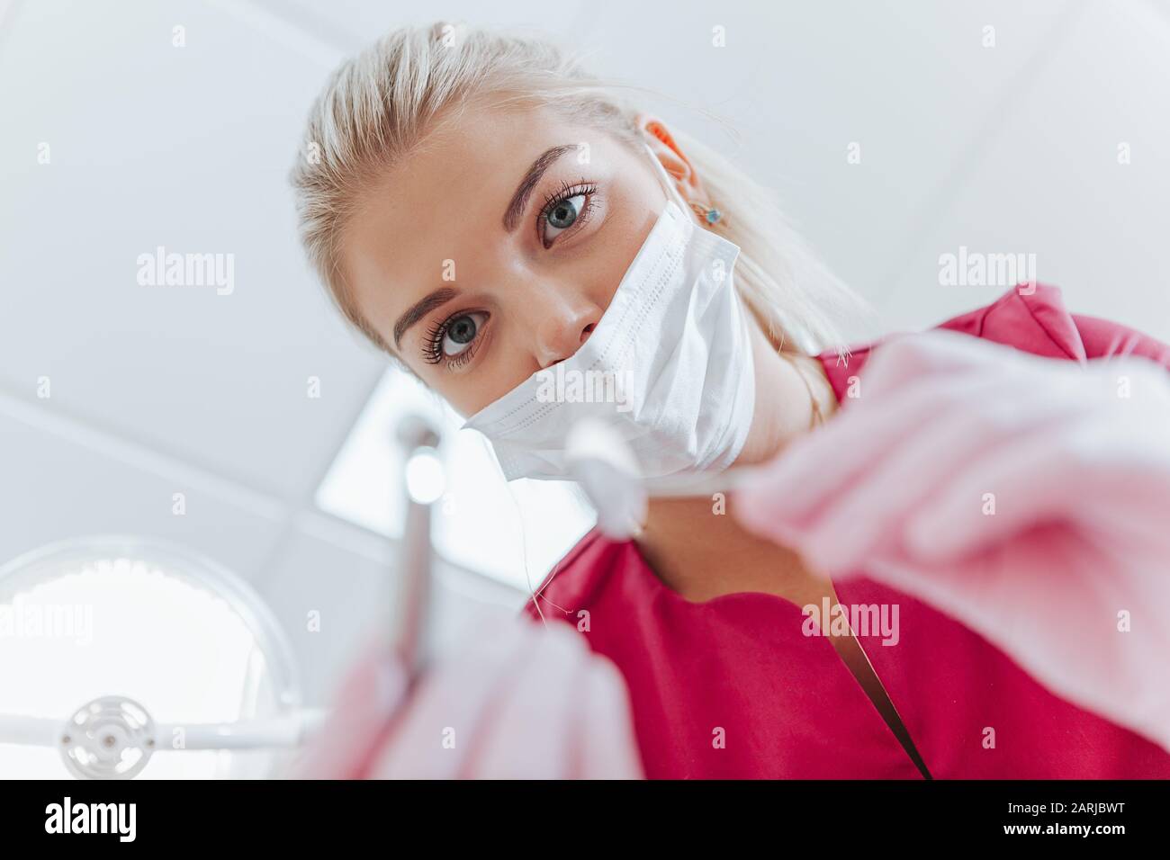 Young doctor in violet uniform making surgery. Virus. Illness.Bottom view Stock Photo