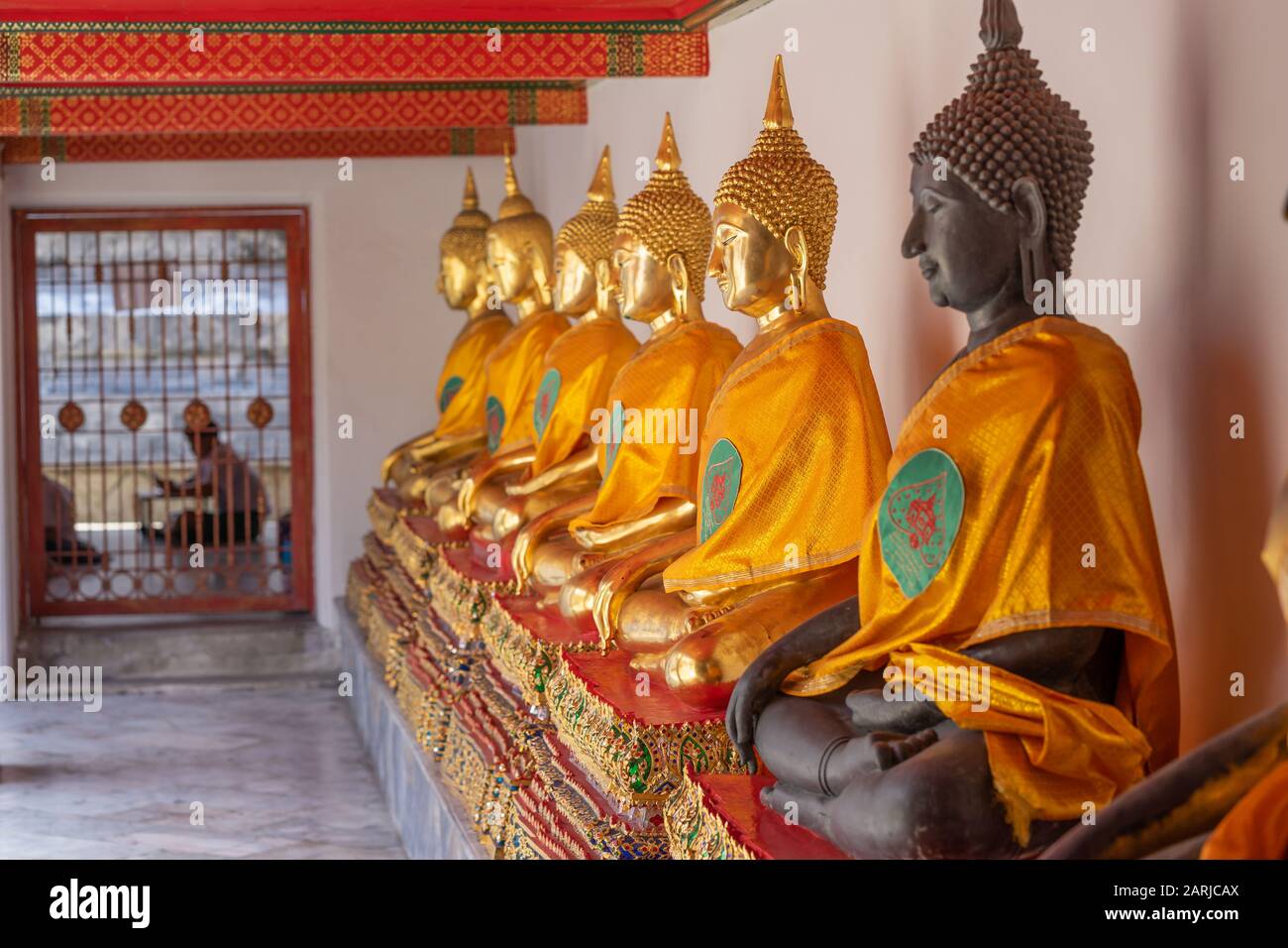 The rows of Buddha Statues in Grand Palace in Bangkok were mesmerizingly beautiful. Stock Photo