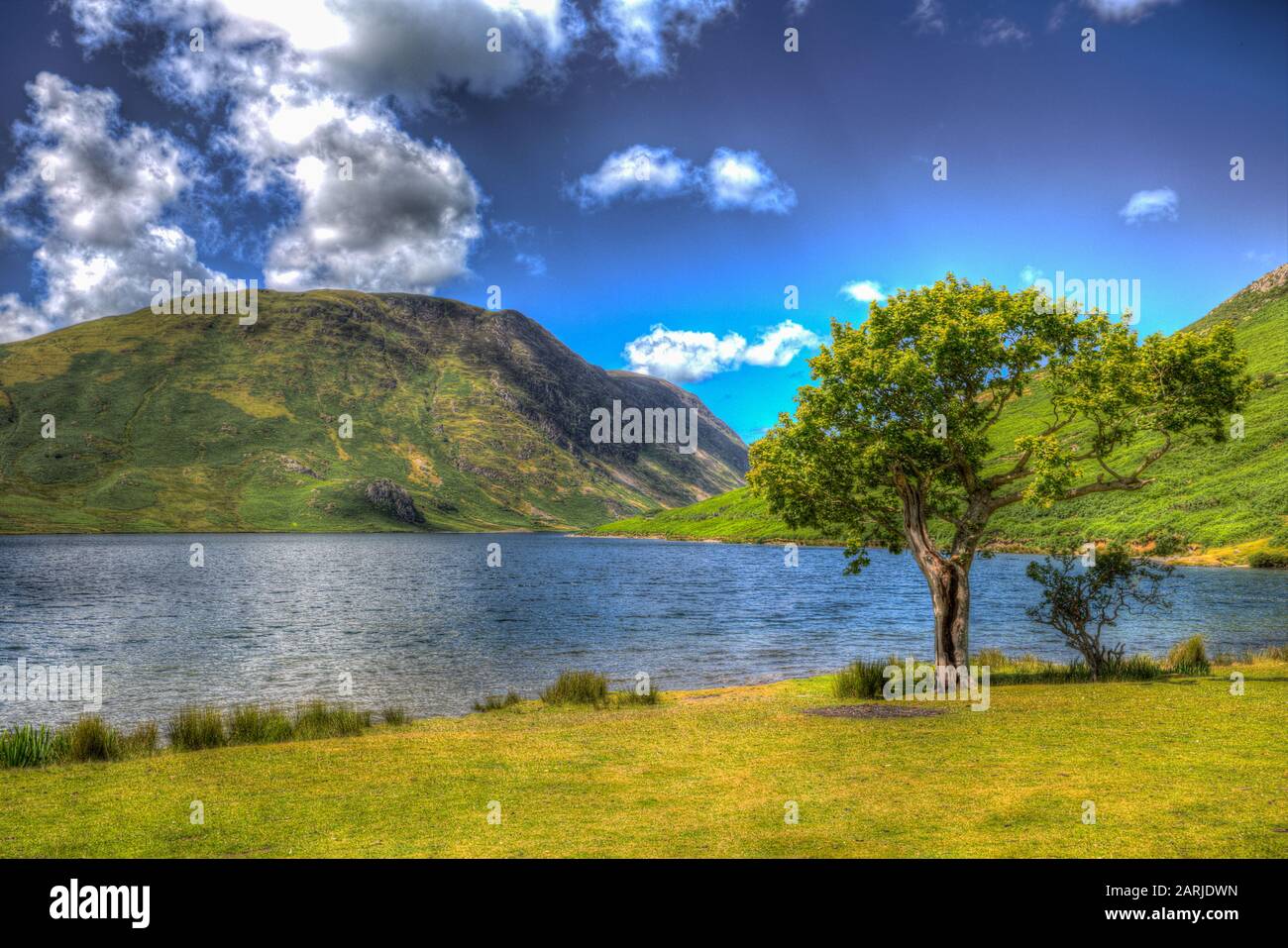 Crummock Water Lake District England with mountains and blue sky in colourful HDR Stock Photo