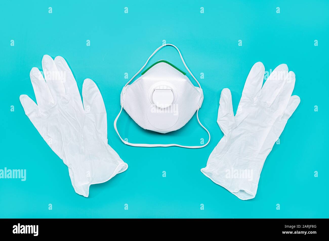 Safety mask and protective gloves isolated on green background. Virus or pollution protection concept Stock Photo