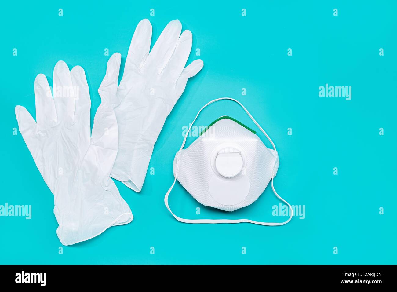 Safety mask and protective gloves isolated on green background. Virus or pollution protection concept. Copy space Stock Photo