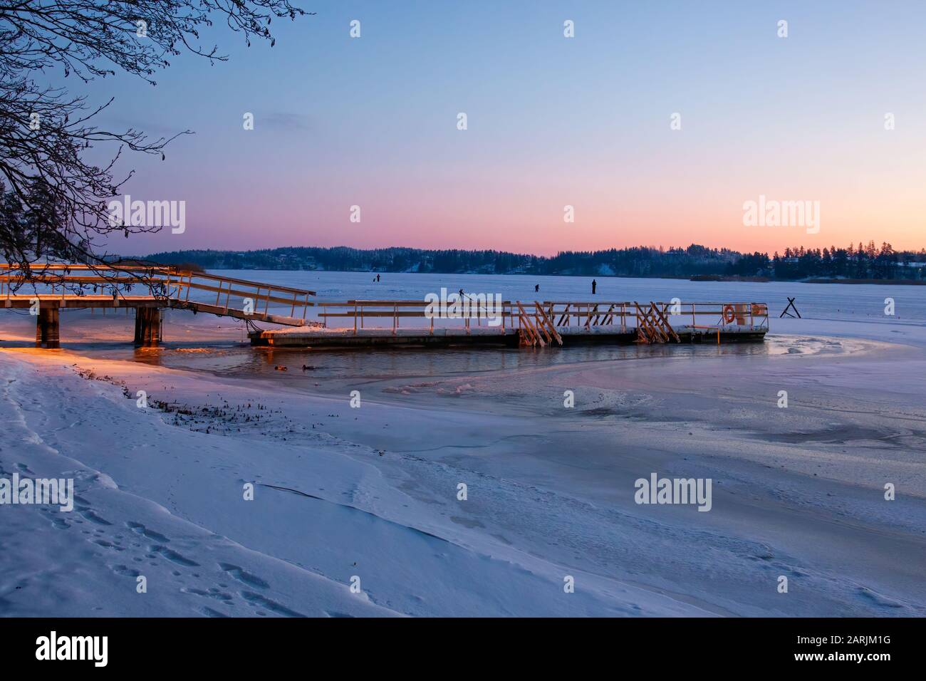 Wonderful winter landscape with snow covered wooden pier, Turku, Finland. Ideal place for ice swimmers. Arctic pool, ice hole. Stock Photo